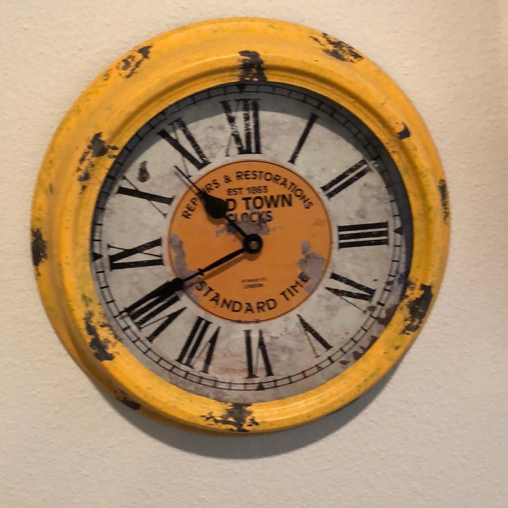 Vintage look yellow wall clock.